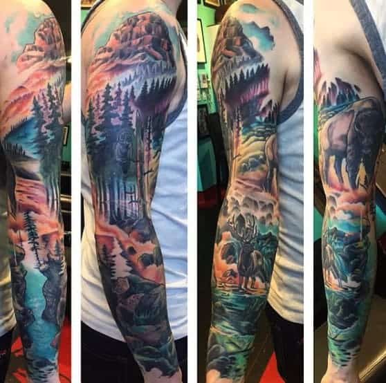 Man with colorful wilderness-themed full sleeve tattoo featuring mountains and forest