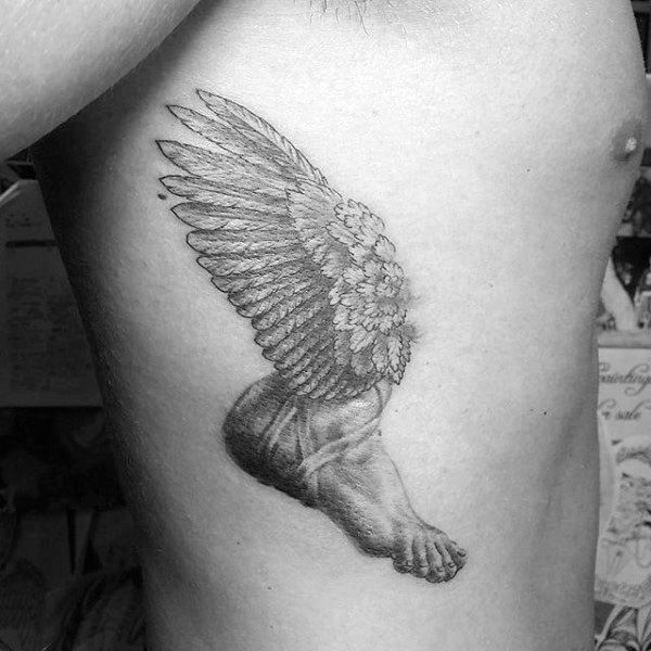 Black and grey tattoo of a winged leg and foot on ribcage