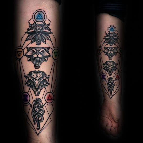 Forearm Witcher tattoo with three distinct wolf medallions, magical sign symbols in color, and a serpent design at the base.