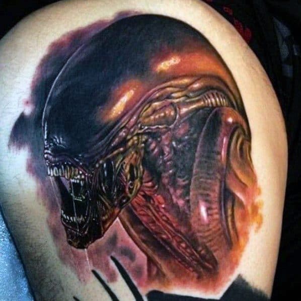 Realistic Xenomorph tattoo in fiery red and orange tones, featuring sharp biomechanical details and a glossy, menacing alien head.