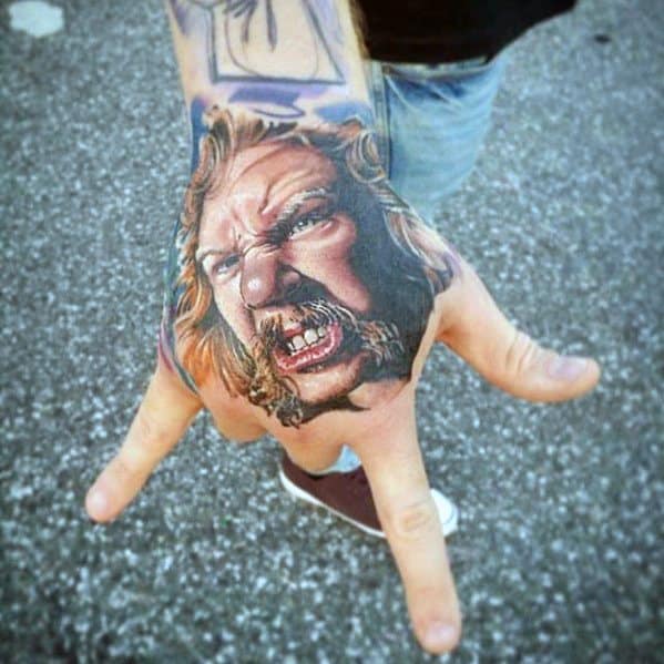 Hyper-realistic color hand tattoo of James Hetfield with an intense, screaming expression, capturing his iconic stage energy and fierce attitude.