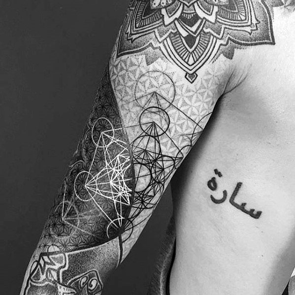 Full sleeve tattoo featuring Metatron’s Cube with fine linework, dot shading, mandalas, and Arabic script reading “سارة” on the ribcage.