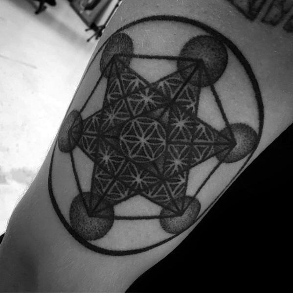 Bold Metatron’s Cube tattoo with dark shaded spheres, layered star patterns, and a thick outer circle creating a strong, dimensional look.