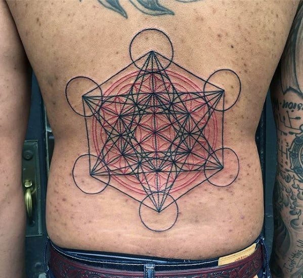 Lower back tattoo of Metatron’s Cube with layered black and red linework, creating a bold and dynamic sacred geometry centerpiece.