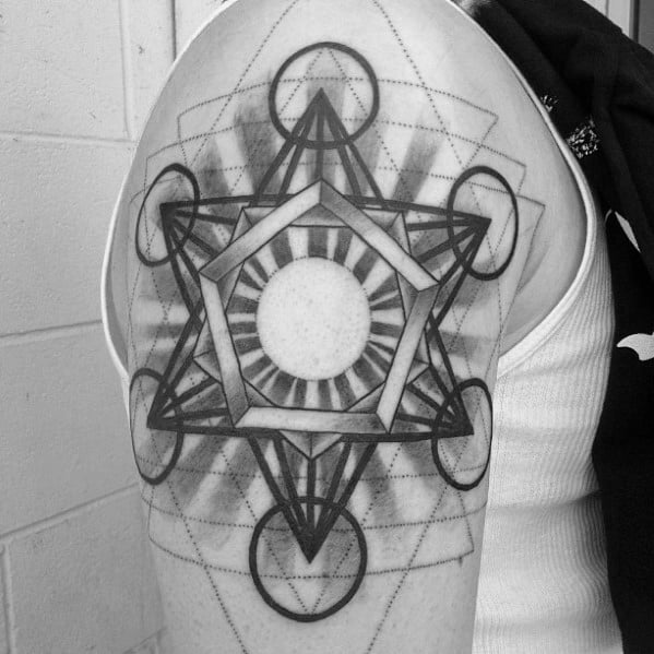 Upper arm Metatron’s Cube tattoo featuring a radiant central circle, bold lines, and layered geometric patterns for a striking visual effect.