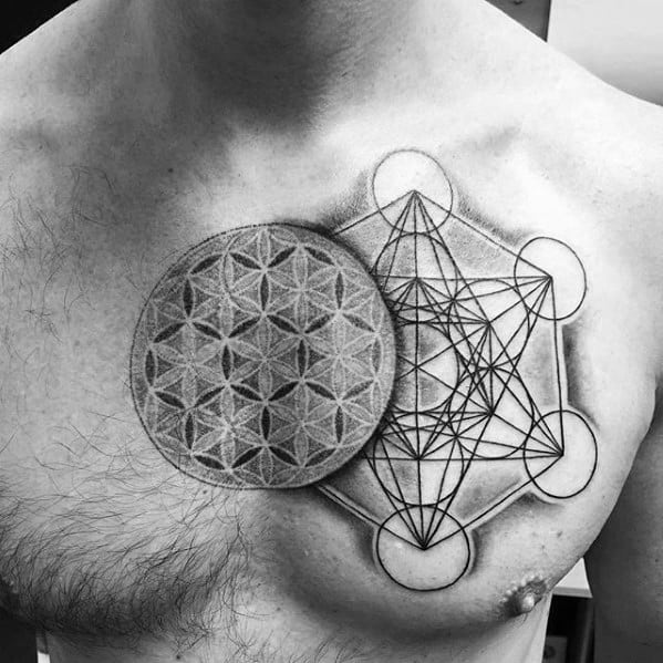 Chest tattoo combining the Flower of Life and Metatron’s Cube, with precise dotwork and linework forming a balanced sacred geometry piece.