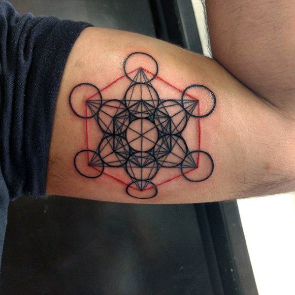 Inner arm tattoo of Metatron’s Cube with bold black and red linework, creating a vivid contrast and a modern sacred geometry aesthetic.