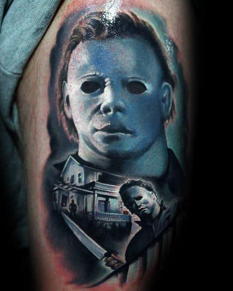 Michael Myers tattoo with a chilling blue-toned mask, the infamous house, and a knife-wielding scene for a haunting horror design.
