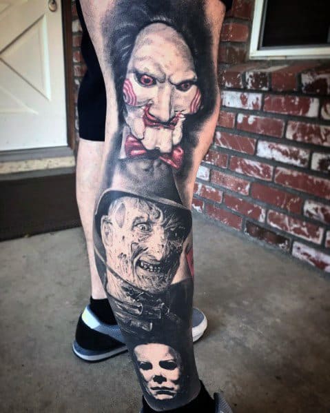 Horror-themed leg sleeve tattoo featuring Billy from Saw, Freddy Krueger, and Michael Myers, blending iconic villains in a chilling design.