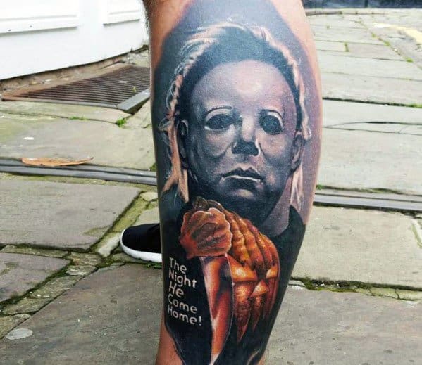 Michael Myers tattoo featuring his chilling mask, a bloody knife, and a carved pumpkin with 'The Night He Came Home!' text.