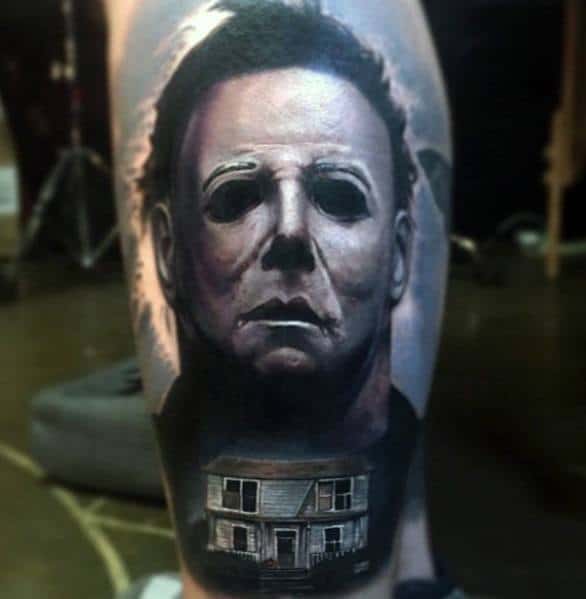 Realistic Michael Myers tattoo featuring his eerie mask with the infamous house below, creating a haunting horror design.