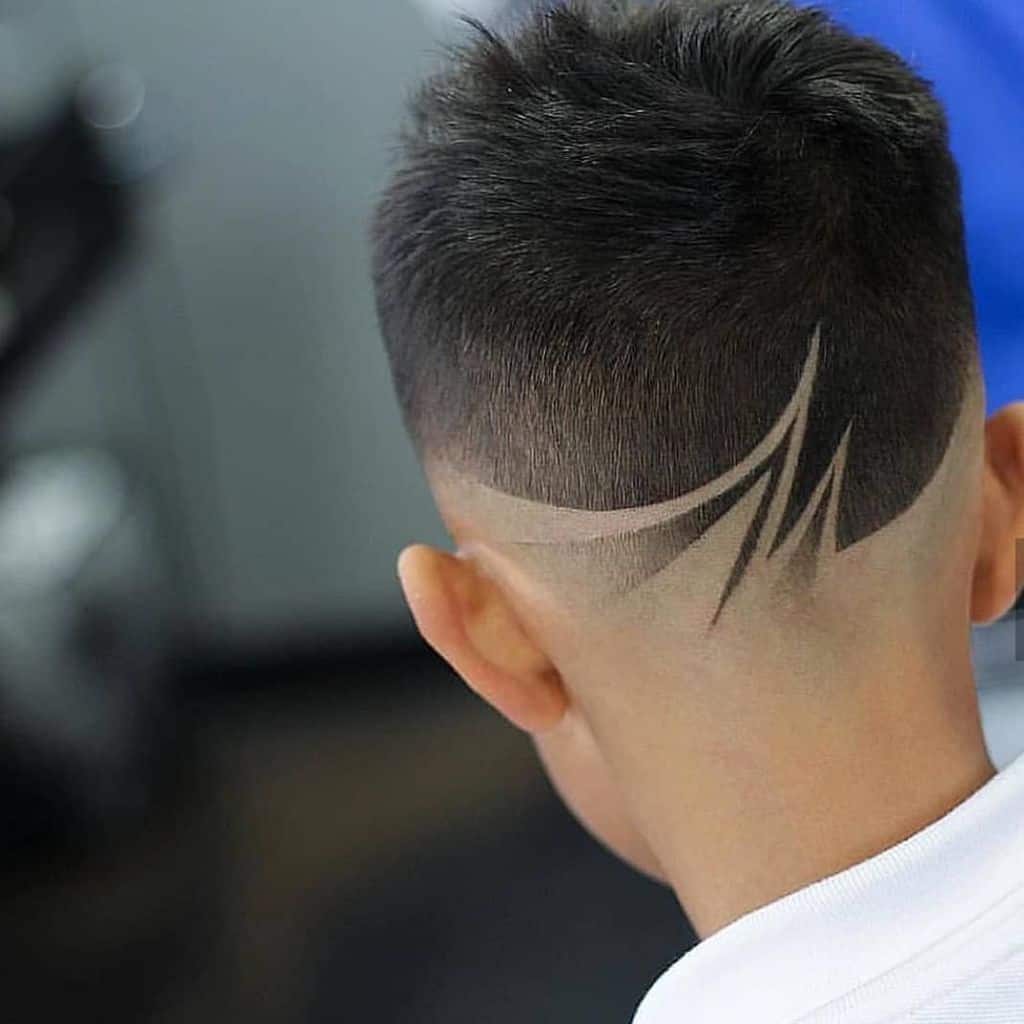 A haircut with slightly long hair on top and lines at the back