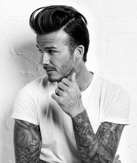 High-volume pompadour with a subtle side part and clean fade