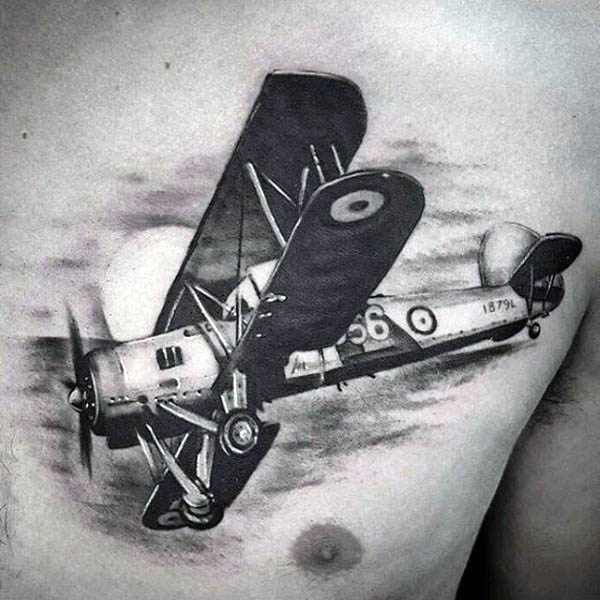 Black and white tattoo of a vintage airplane on a person's chest