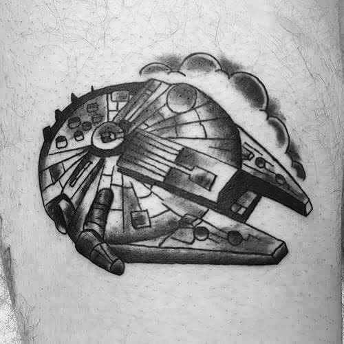 Black and grey Millennium Falcon tattoo with bold shading and soft clouds in the background for a dynamic, classic look.