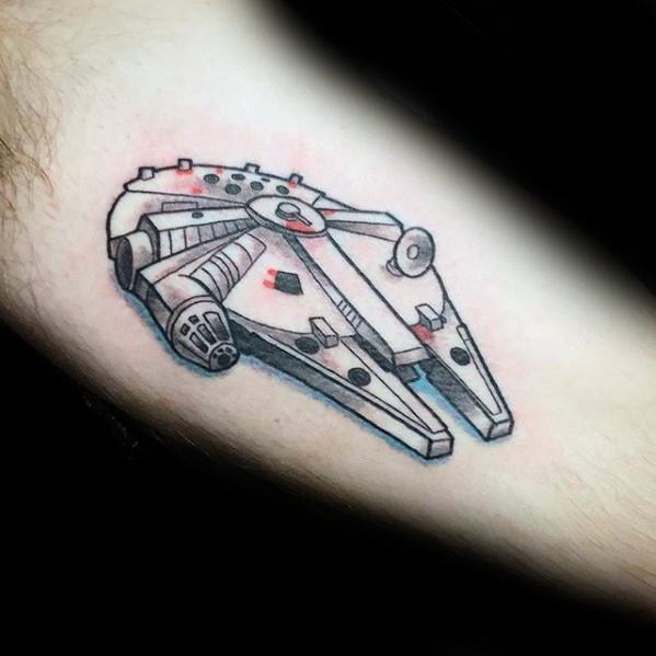 Small Millennium Falcon tattoo with clean lines, soft red and blue accents, and a subtle 3D effect for a modern minimalist look.