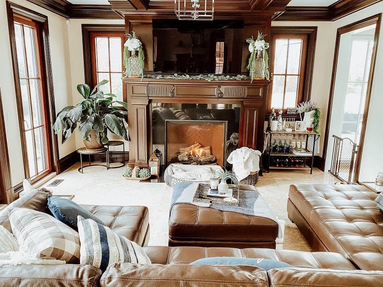 small living room with brown leather sofa and elegant fireplace