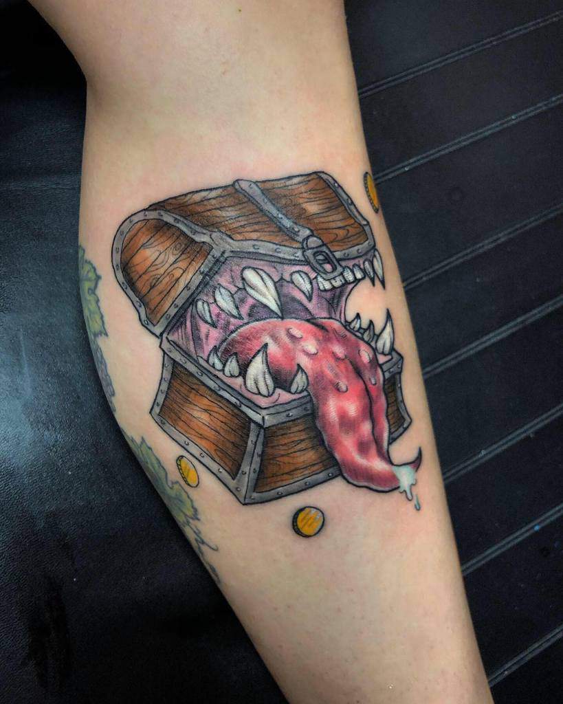 Colorful Dungeons & Dragons tattoo of a Mimic, a monstrous treasure chest with sharp teeth, a dripping tongue, and scattered gold coins