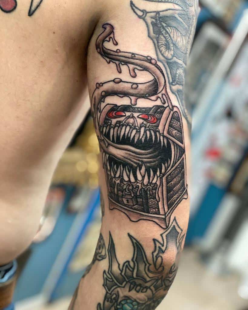 Dark fantasy Dungeons & Dragons tattoo of a Mimic chest with sharp teeth, red eyes, and dripping tentacles, ready to strike