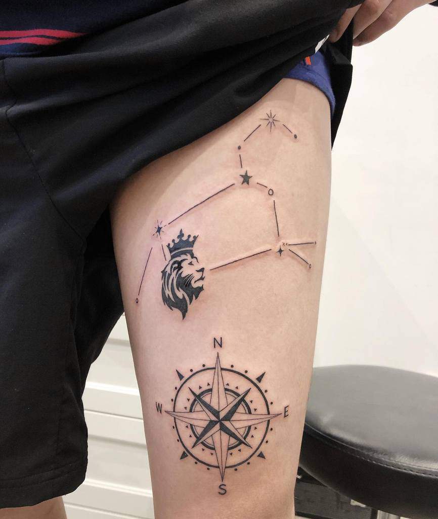 Astrology and navigation-themed tattoo blending the Leo zodiac constellation, a crowned lion, and a nautical compass.
