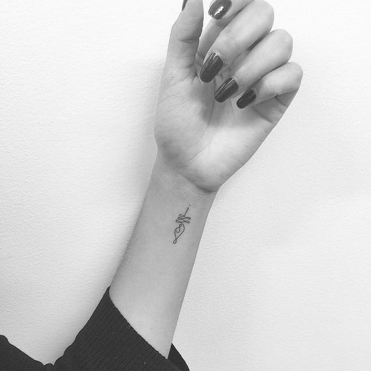 Minimalist Unalome tattoo on the wrist, symbolizing the journey to enlightenment, personal growth, and spiritual balance.