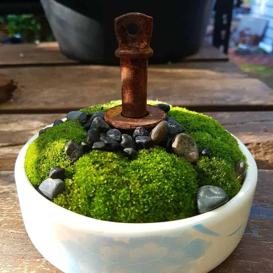 mini-zen garden with rusted metal ornament 