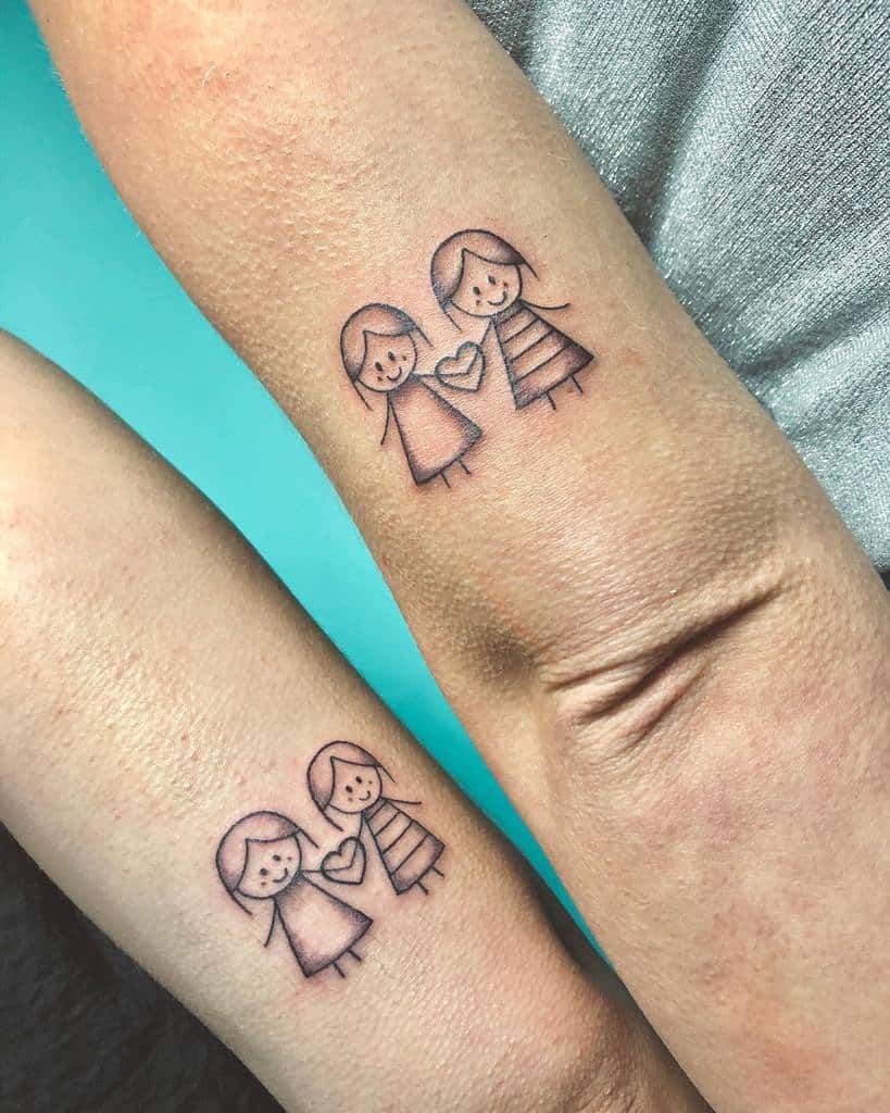 Matching sister tattoos featuring two stick-figure girls holding a heart, symbolizing love and a strong sibling bond