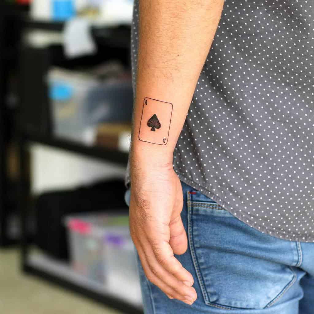 A minimalist black tattoo of the Ace of Spades card, with simple and clean lines
