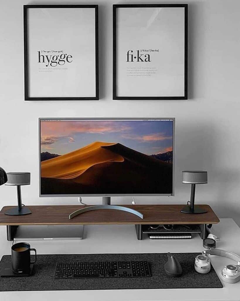 minimalist desk setup framed art work