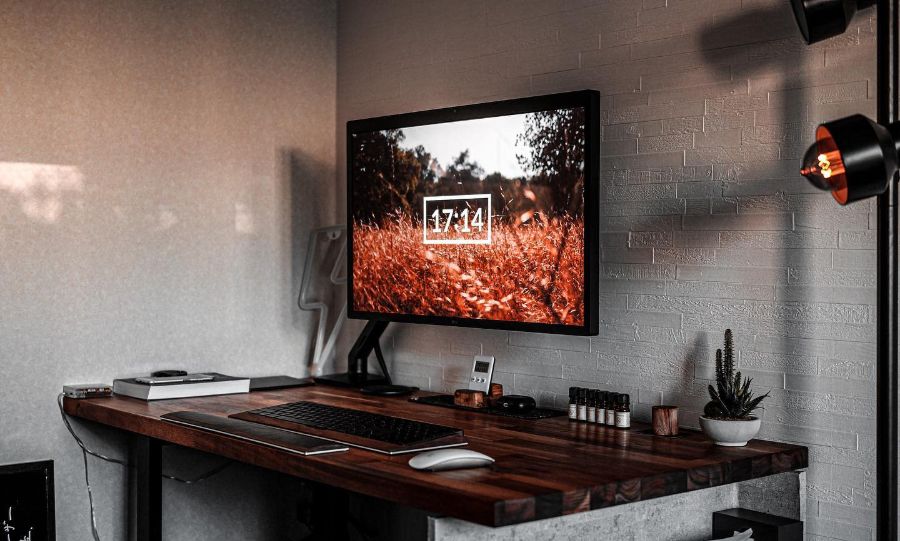 minimalist desk setup large monitor cactus