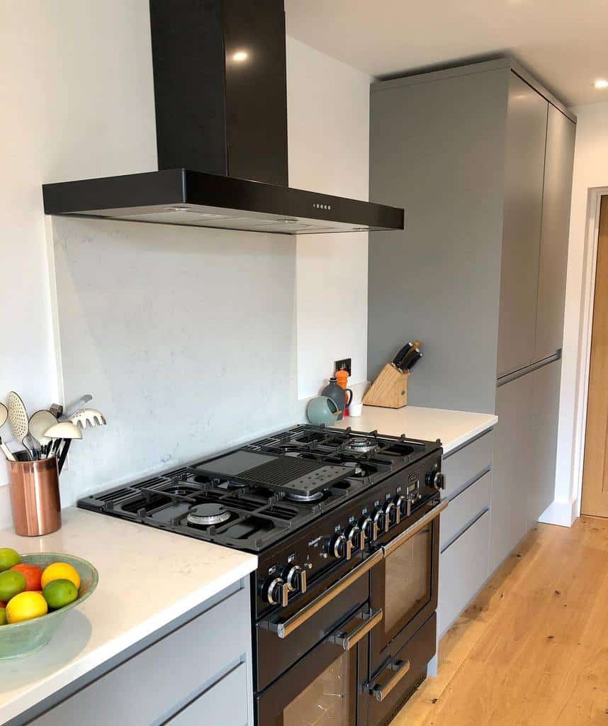 simple galley kitchen white countertop gray cabinets