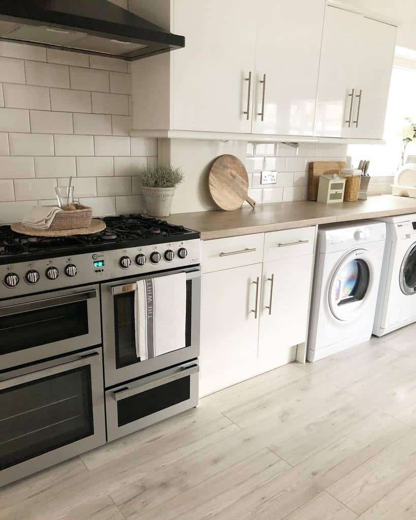 minimalist galley kitchen white cabinets washing machine and dryer