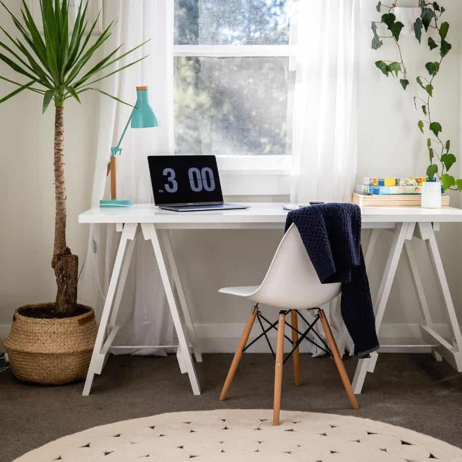 minimalist home office desk white chair blue lamp plant