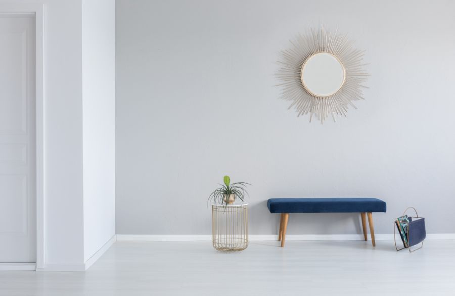 minimalist white mid-century living room with blue bench seat