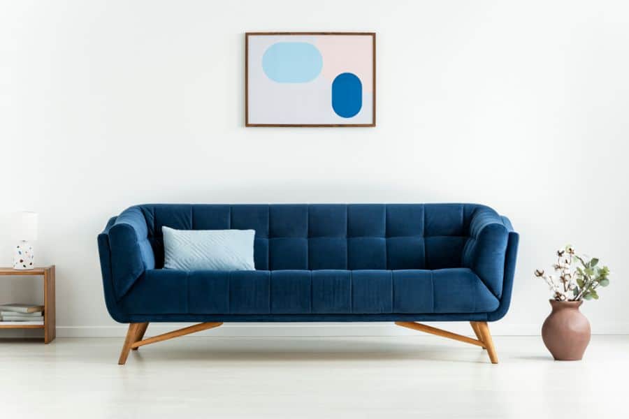 blue sofa in minimalist mid-century living room 