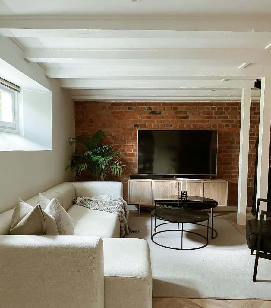 minimalist downstairs living room with brick accent wall