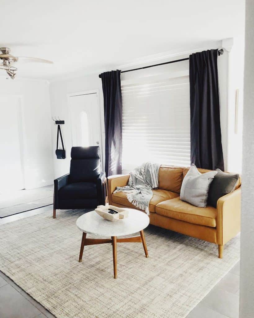 white minimalist living room with tan sofa 