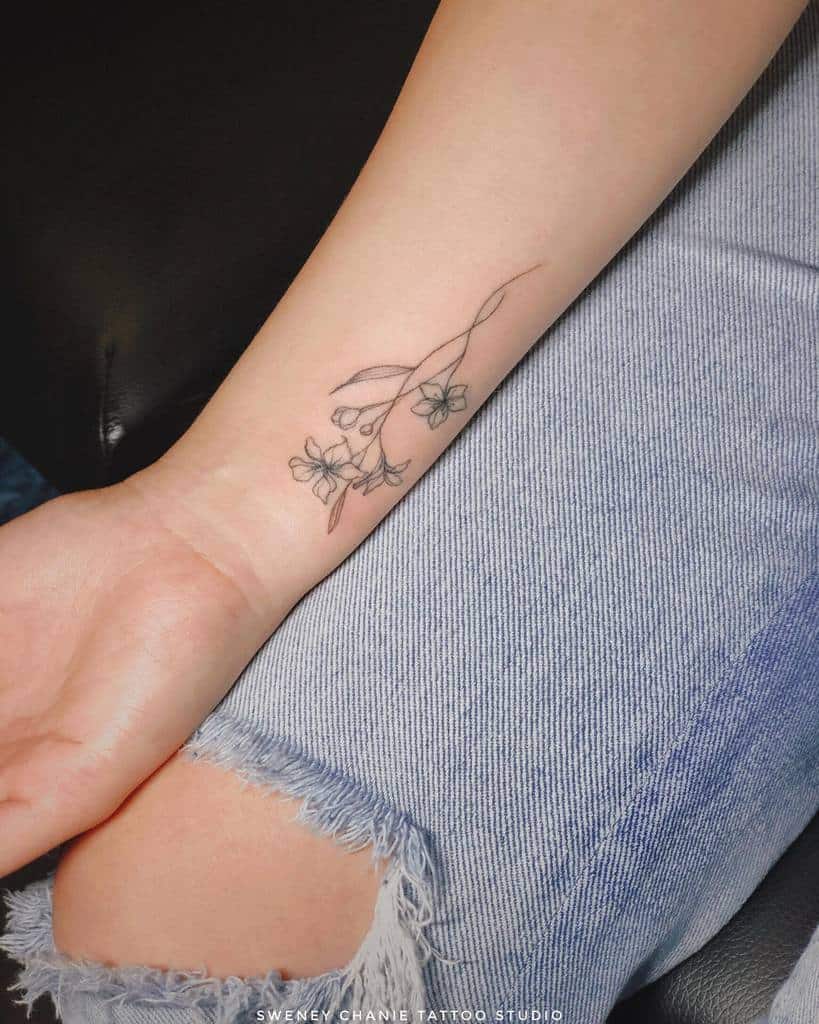 Minimalist jasmine tattoo on a wrist