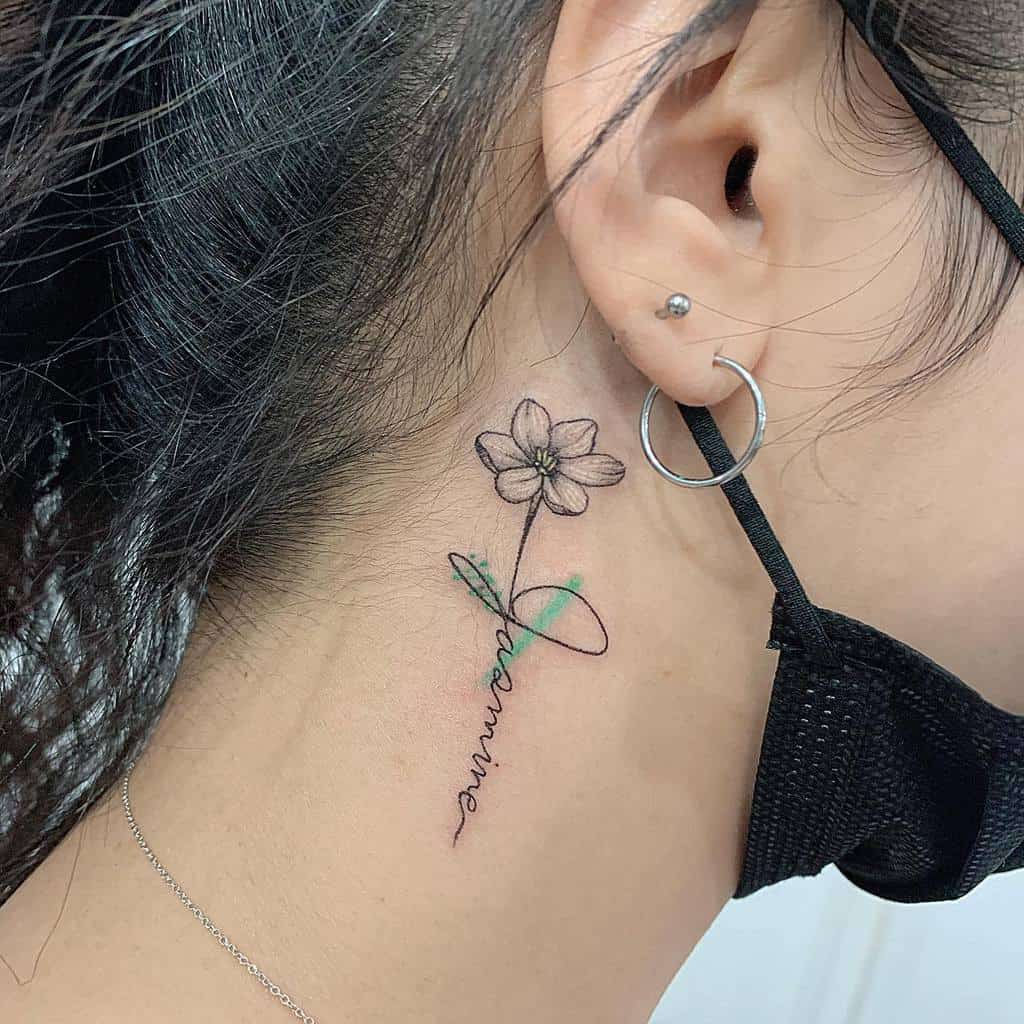 Simple neck tattoo of jasmine flower and the word "dreaming"