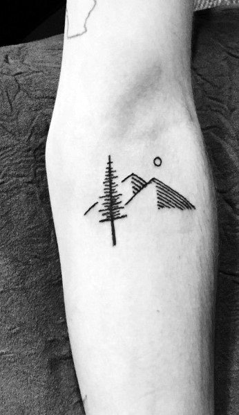 Minimalist mountain tattoo on the forearm, featuring a simple tree, fine line peaks, a small sun, and subtle shading for a modern nature-inspired design.