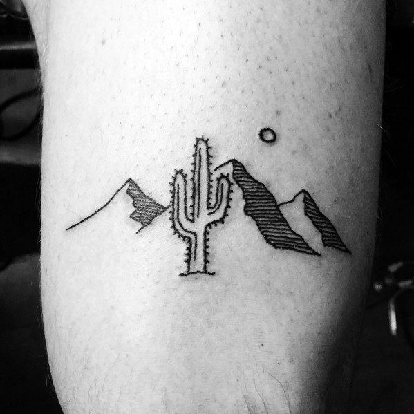 Minimalist desert mountain tattoo, featuring fine line peaks, a cactus, a small sun, and subtle shading for a simple yet bold nature-inspired design.