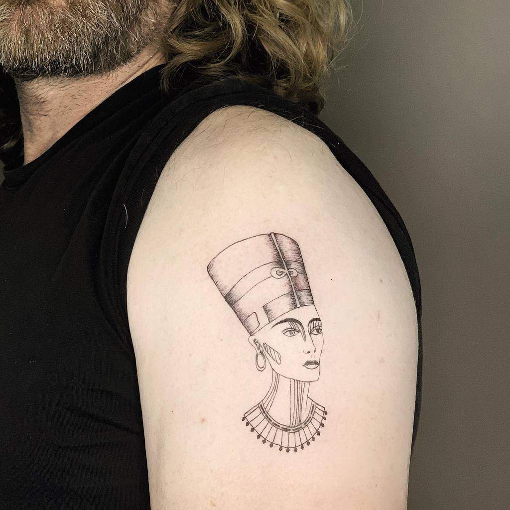 Arm tattoo of ancient Egyptian Queen Nefertiti with a headdress and necklace
