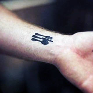 Tattoo of a fork, spoon, and knife on a wrist