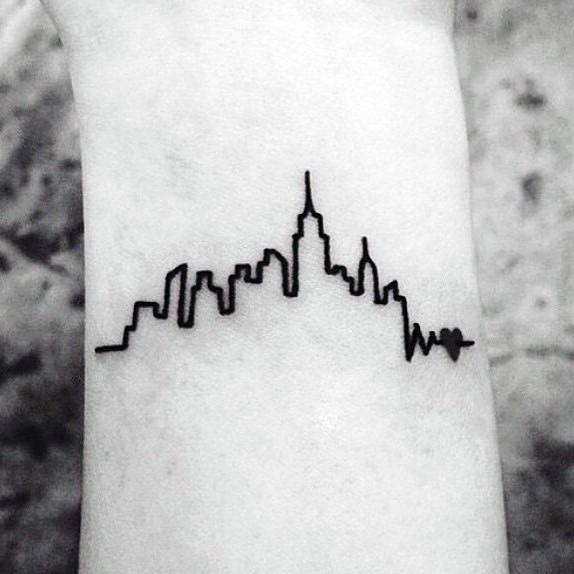 Minimalist wrist tattoo of the New York City skyline with a heartbeat line ending in a heart symbol, done in bold black ink.