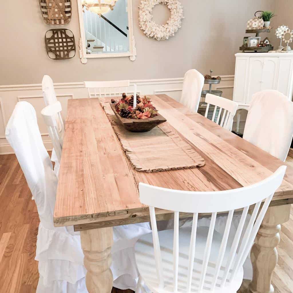 rustic farmhouse wood dining room table white chairs white framed wall mirror 