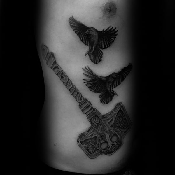 Mjolnir With Two Black Crows Flying Mens Rib Cage Side Tattoo Ideas