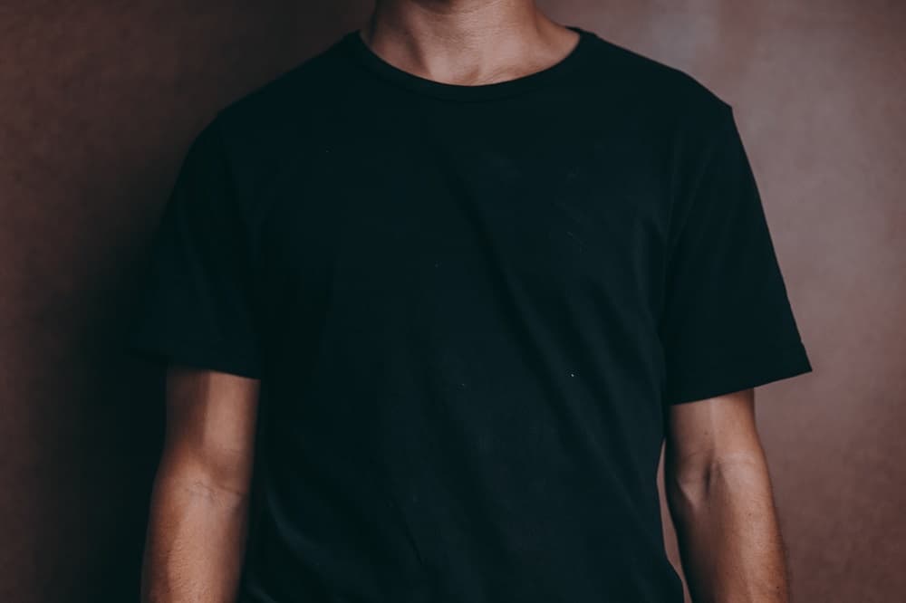 shot of the torso of a model wearing a fitted black t-shirt
