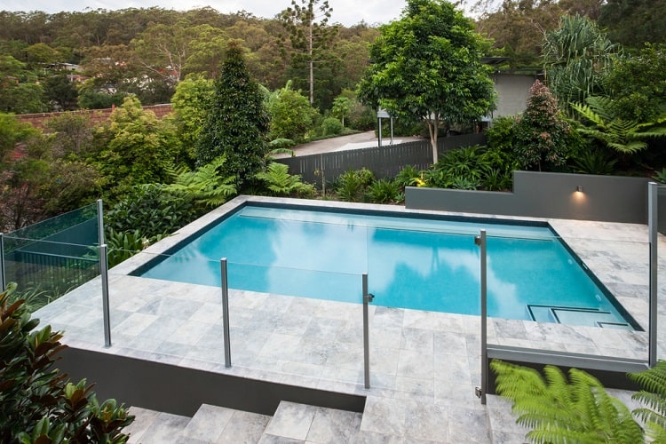 modern grey above ground pool deck with glass fence