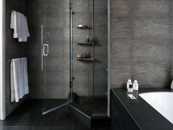 Modern bathroom with glass shower and towels on the wall