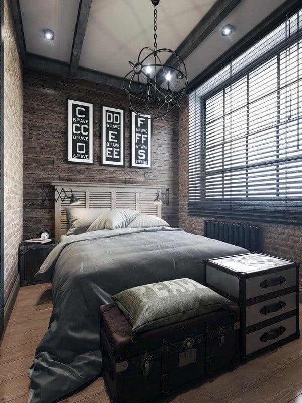 Industrial bedroom with exposed brick walls, black window shutters, and vintage decor.